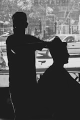 silhouette of man in front of window