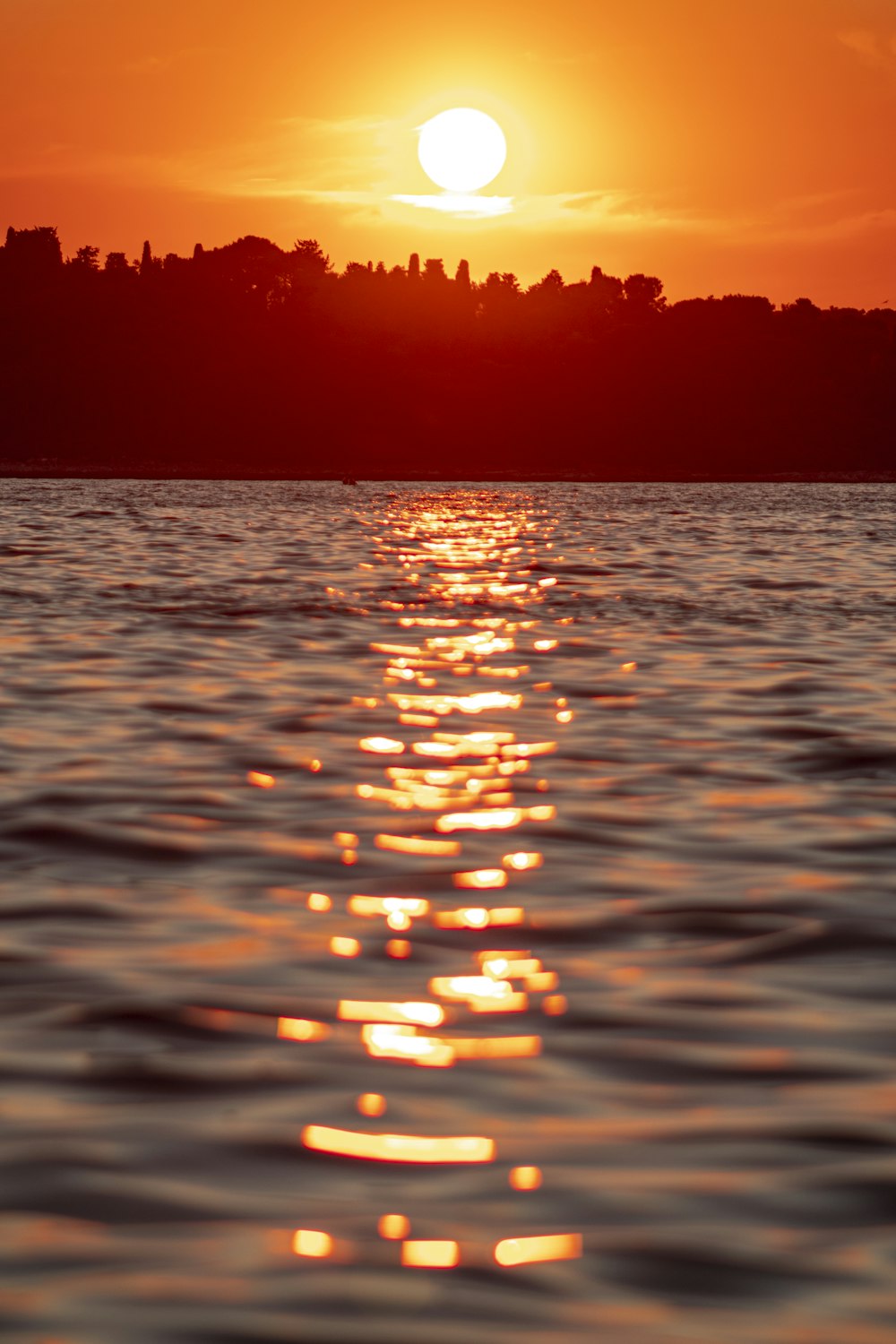 body of water during sunset