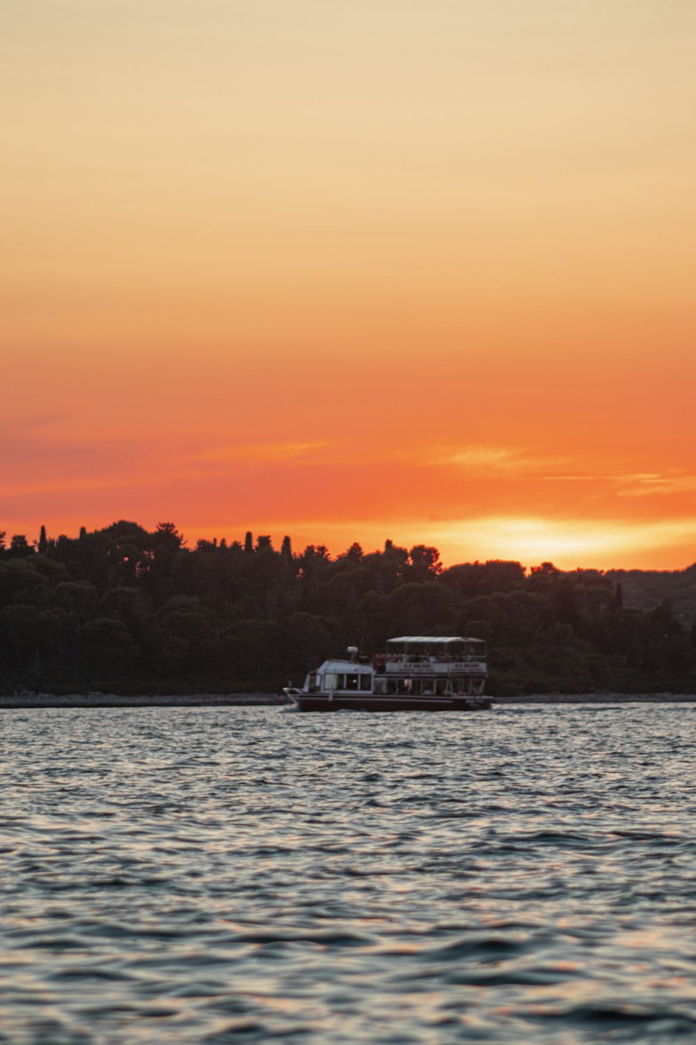 white boat on sea during sunset