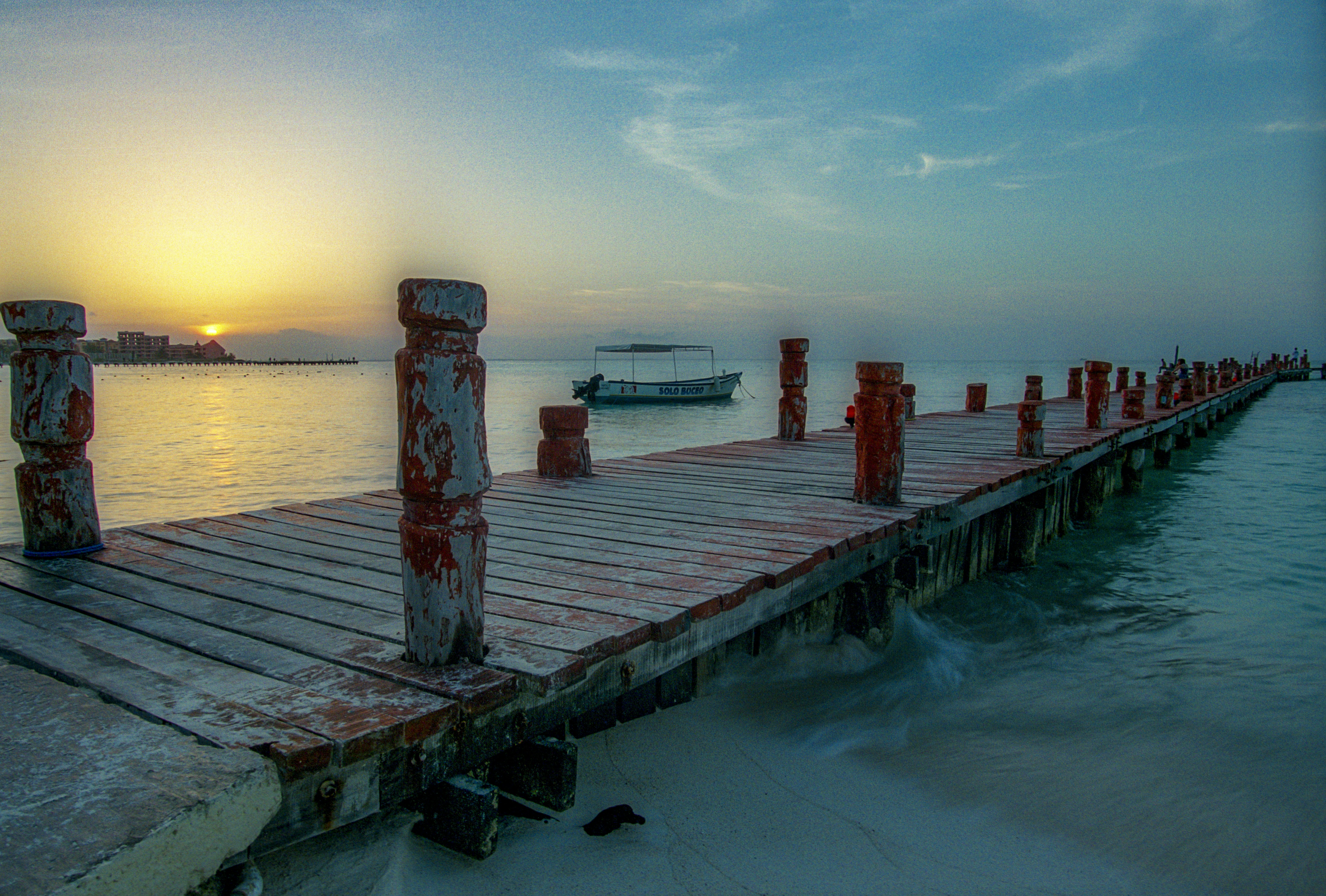 brown wooden dock on body of water during daytime