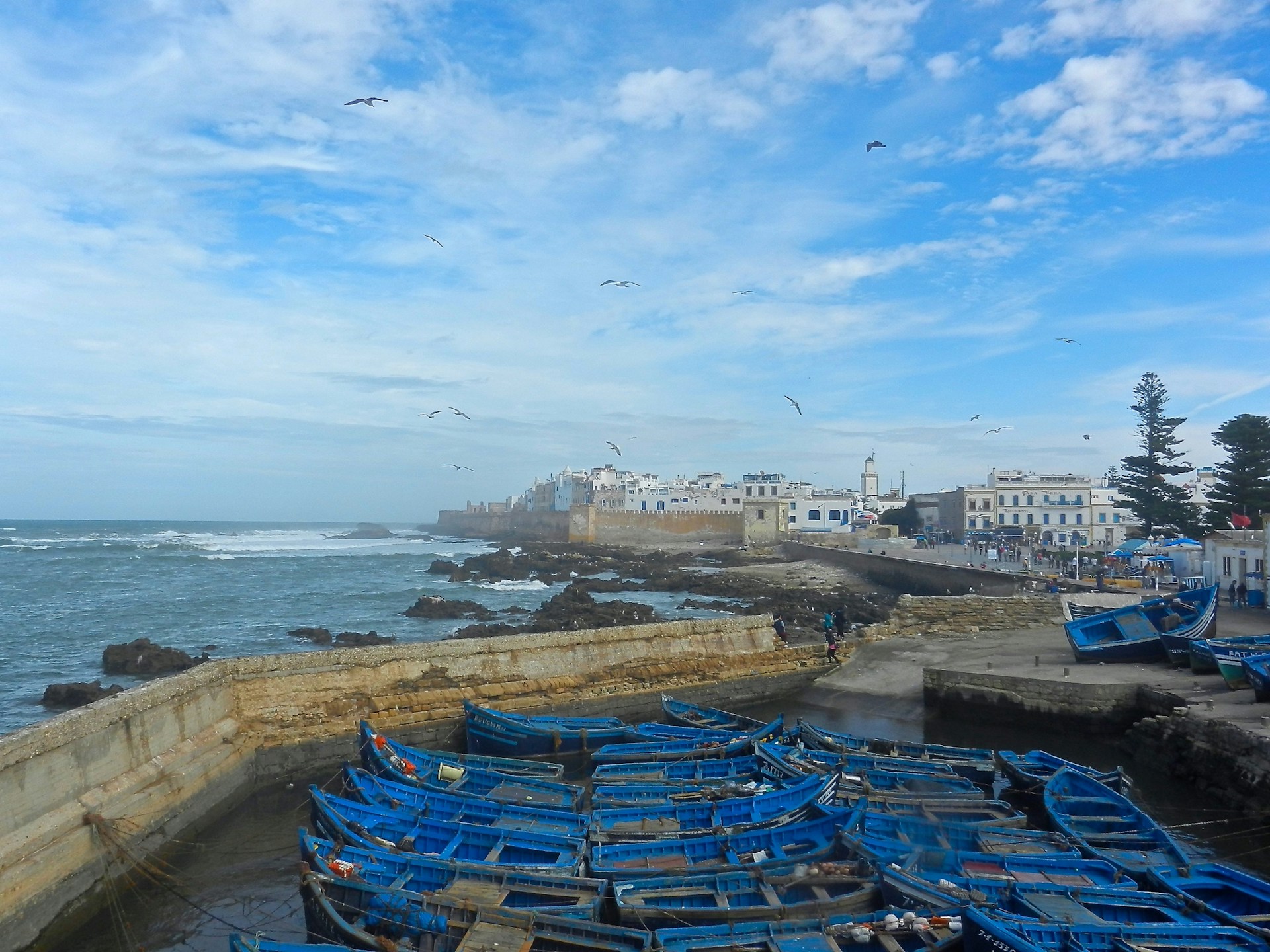 woman wearing yellow long-sleeved dress under white clouds and blue sky during daytime