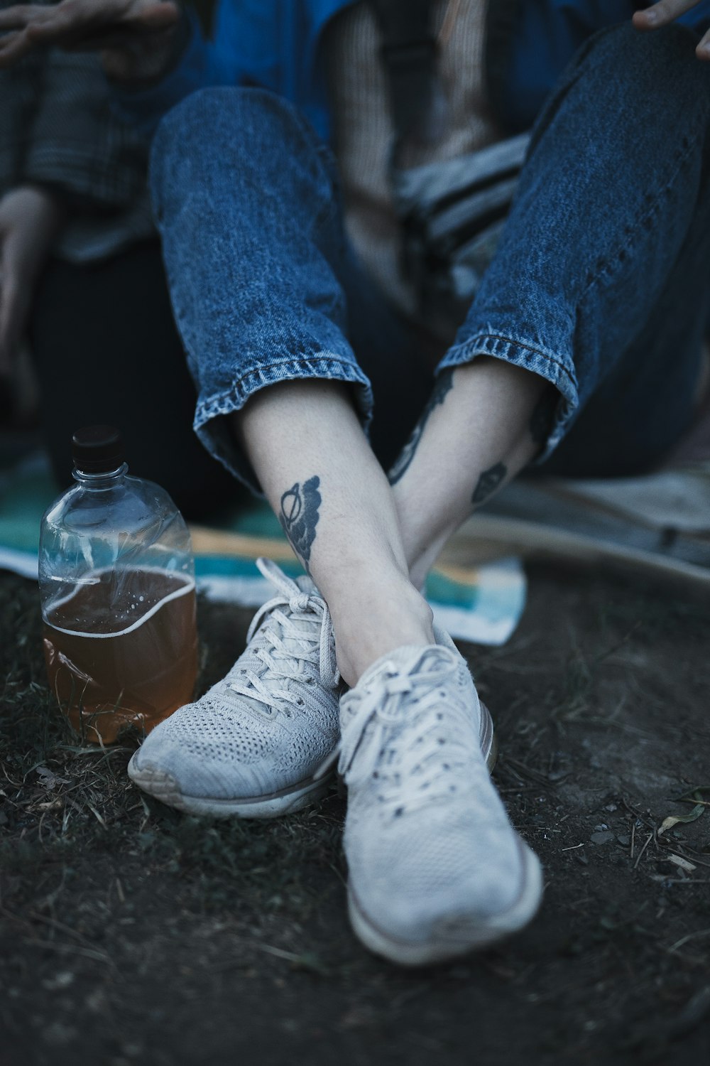 person in blue denim jeans and white nike sneakers