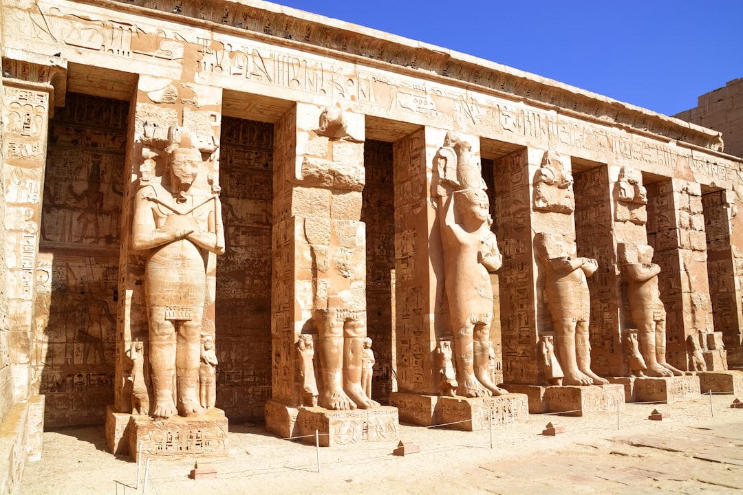 brown concrete statues under blue sky during daytime