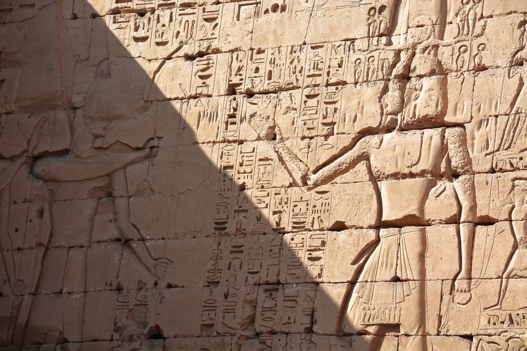 brown concrete wall with human face carved