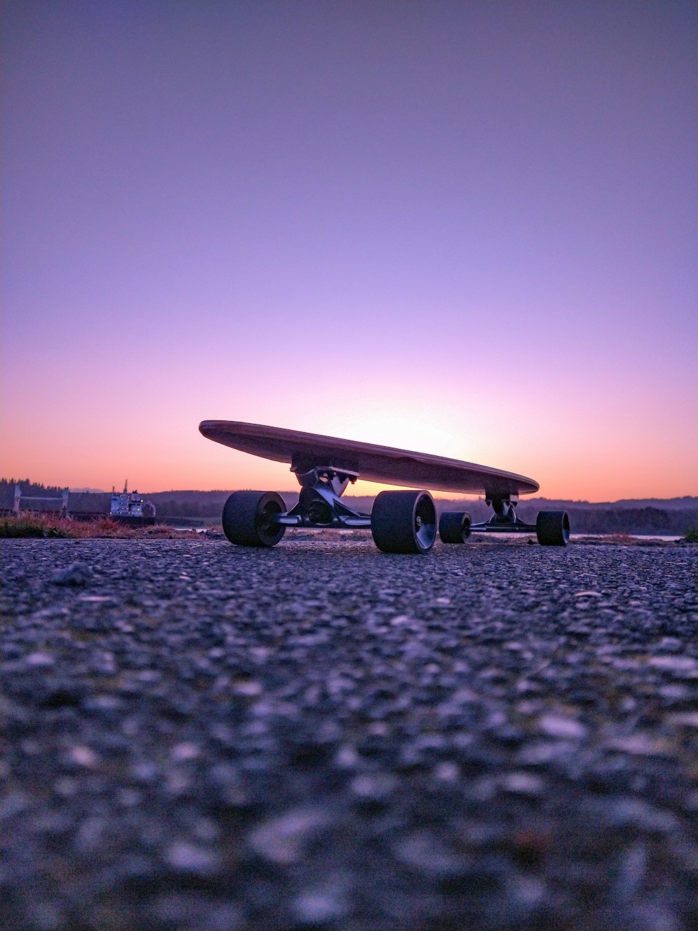 black plane on gray concrete ground during sunset