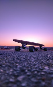 black plane on gray concrete ground during sunset