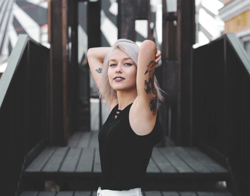 Woman in a black tank top and white skirt