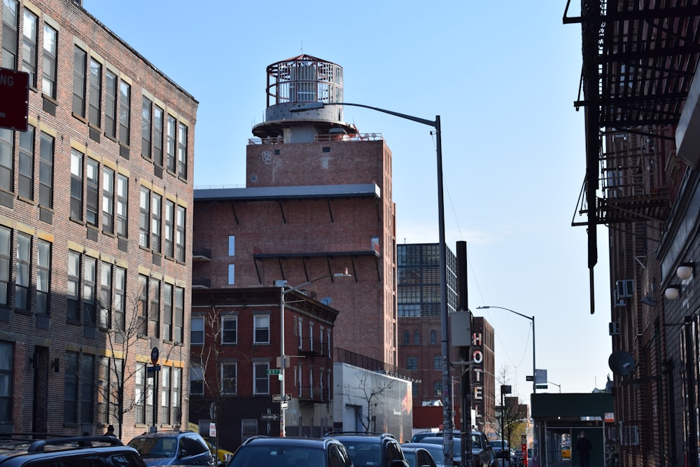 cars parked beside brown concrete building during daytime