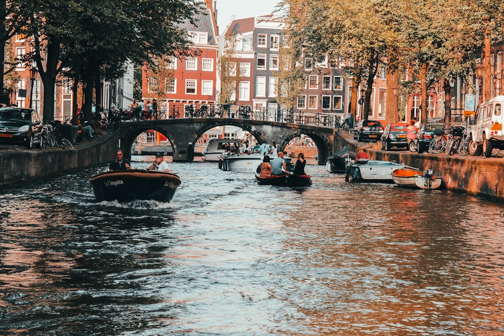 people riding boat on river during daytime