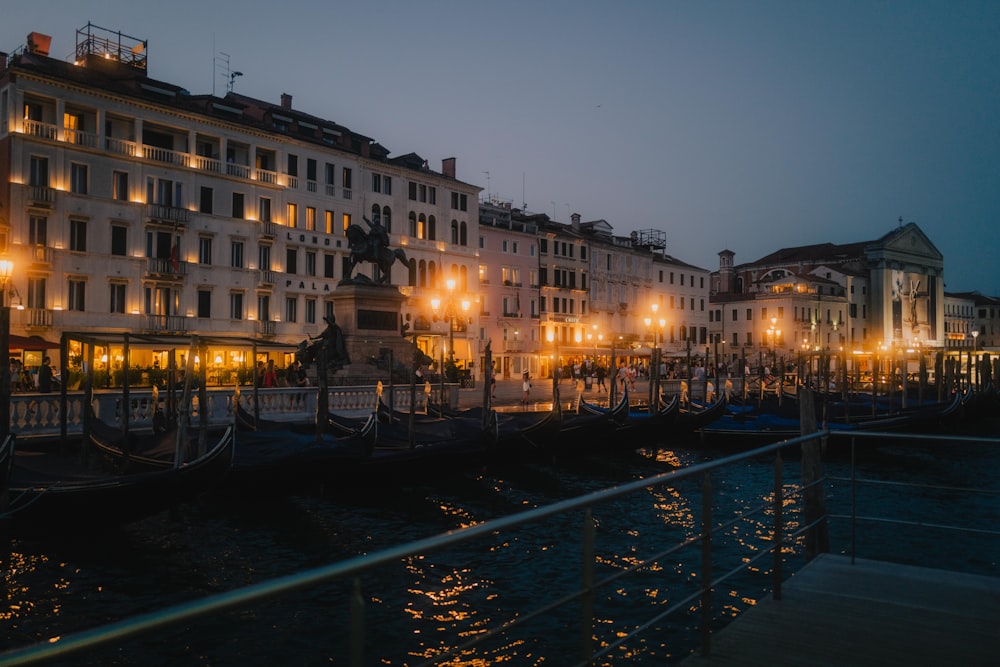 brown concrete building near body of water during night time