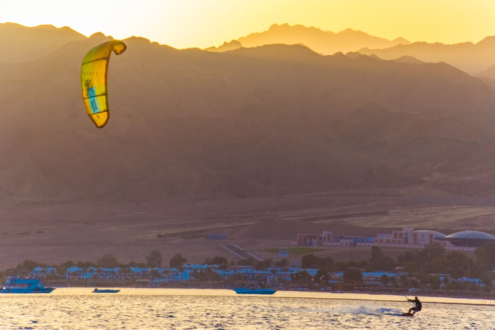 yellow and blue parachute over the city during daytime