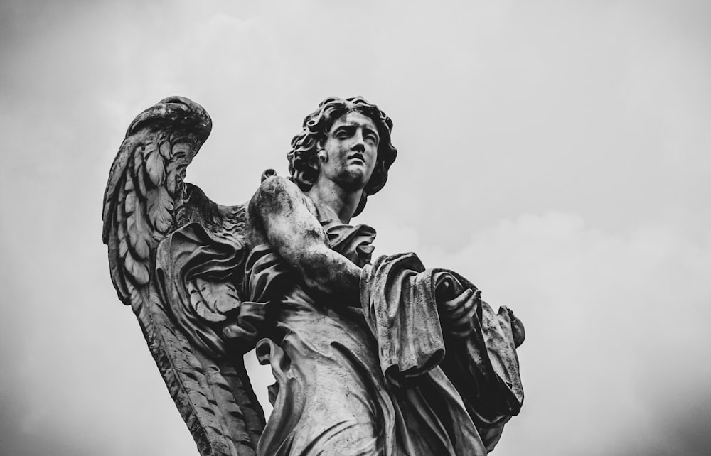 grayscale photo of woman statue