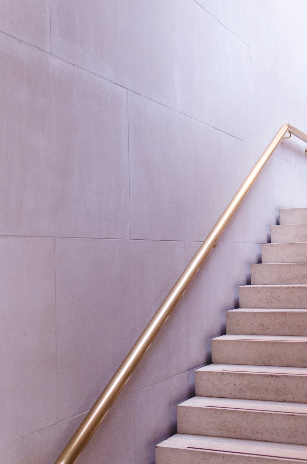 gray concrete staircase with stainless steel railings