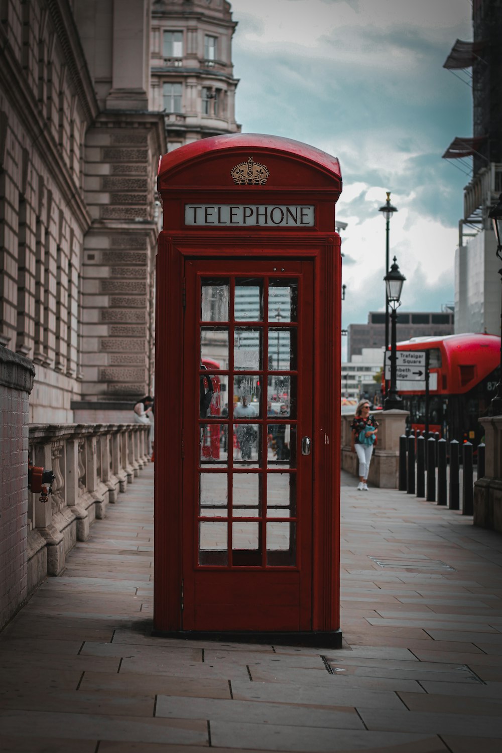red telephone booth near building during daytime