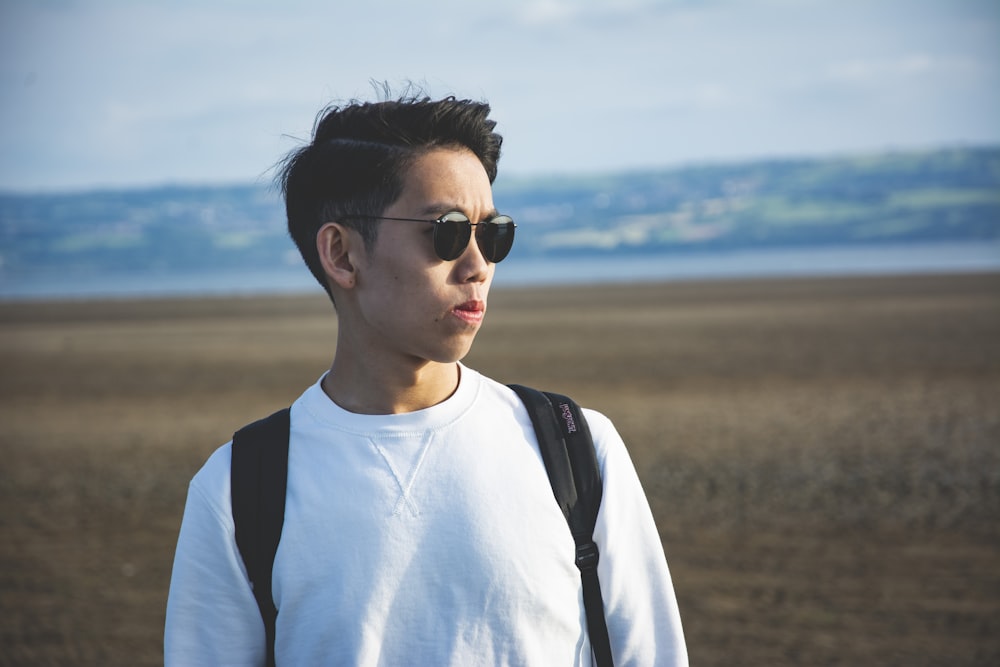 man in white crew neck shirt wearing black sunglasses