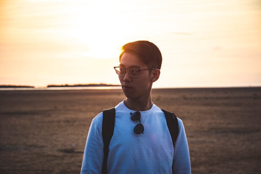 man in blue crew neck shirt wearing eyeglasses