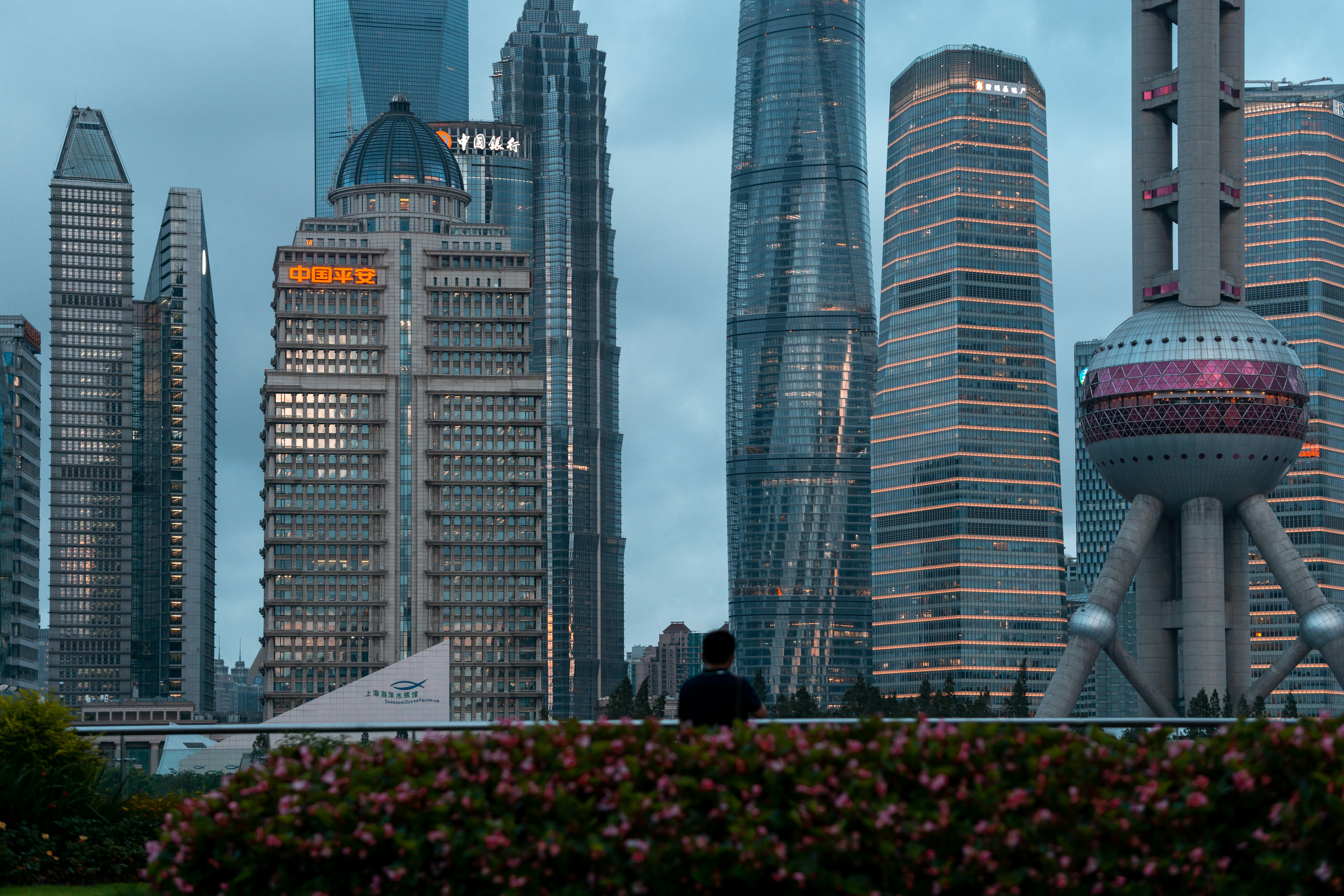 People walking on pathway near high rise buildings during daytime photo ...
