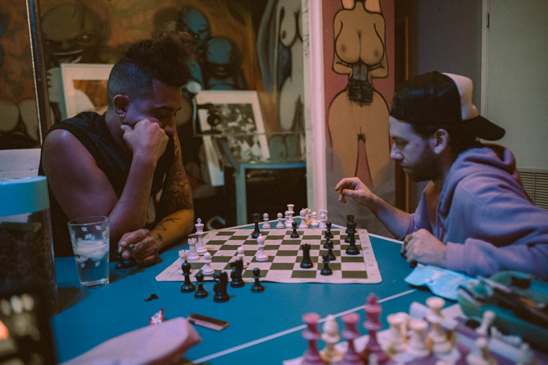 woman in black tank top playing chess