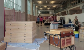 Wide view of a workshop space filled with cardboard materials and creative projects in progress.