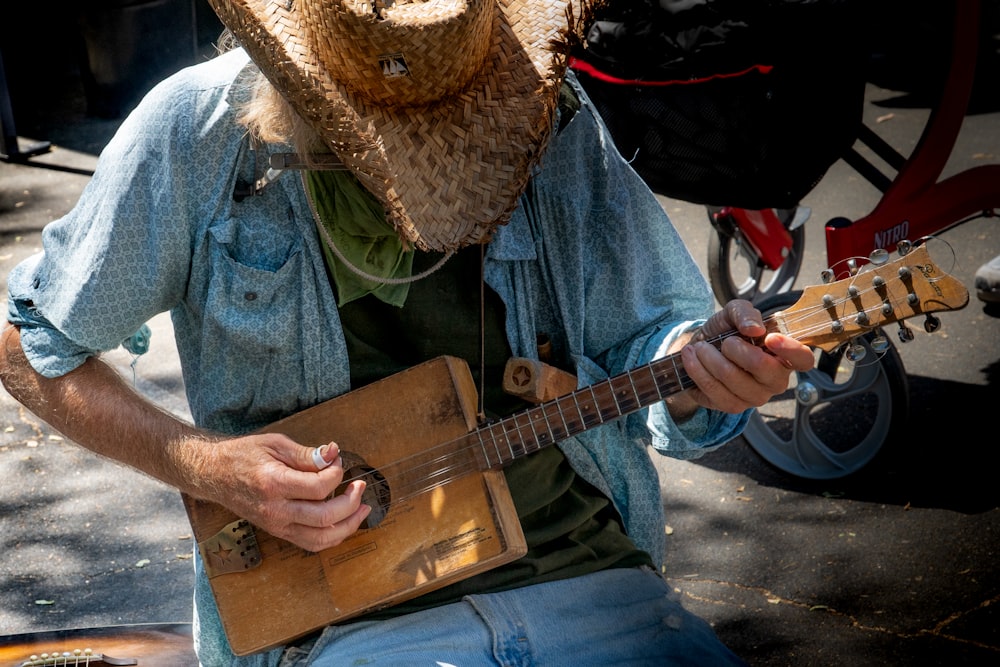 man in blue denim jacket playing brown acoustic guitar photo – Free Farmers  markets Image on Unsplash