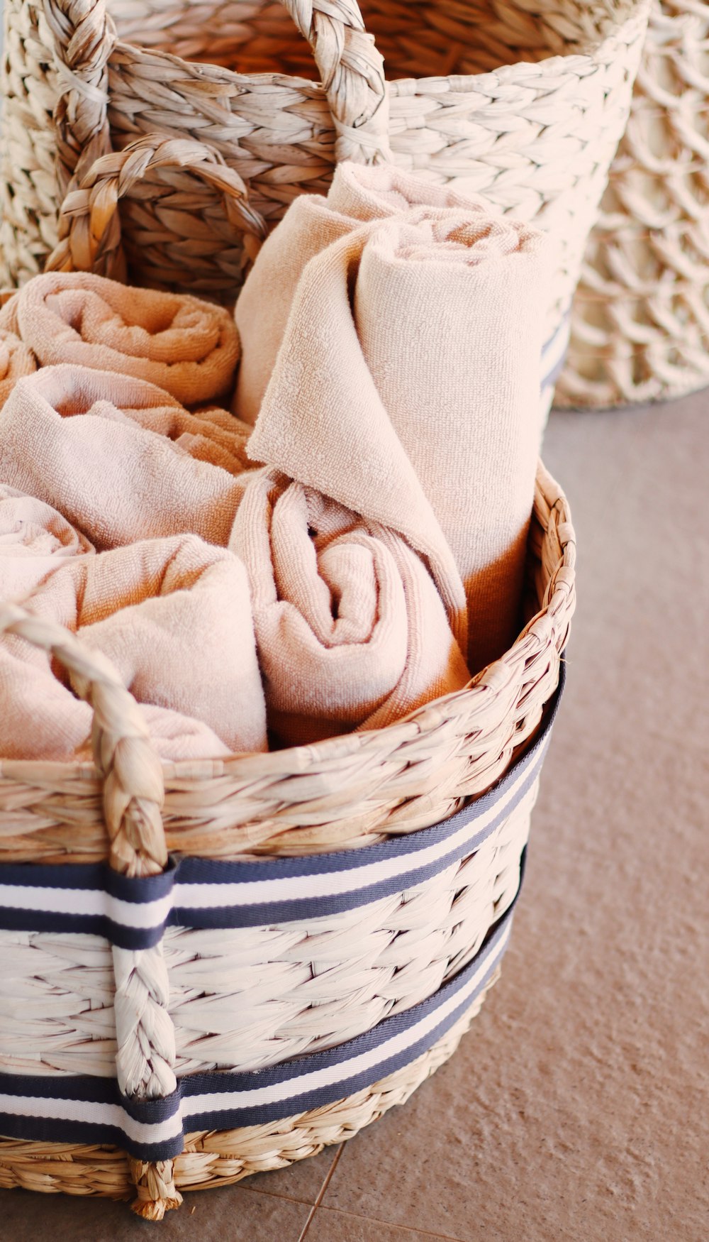 brown textile on white woven basket