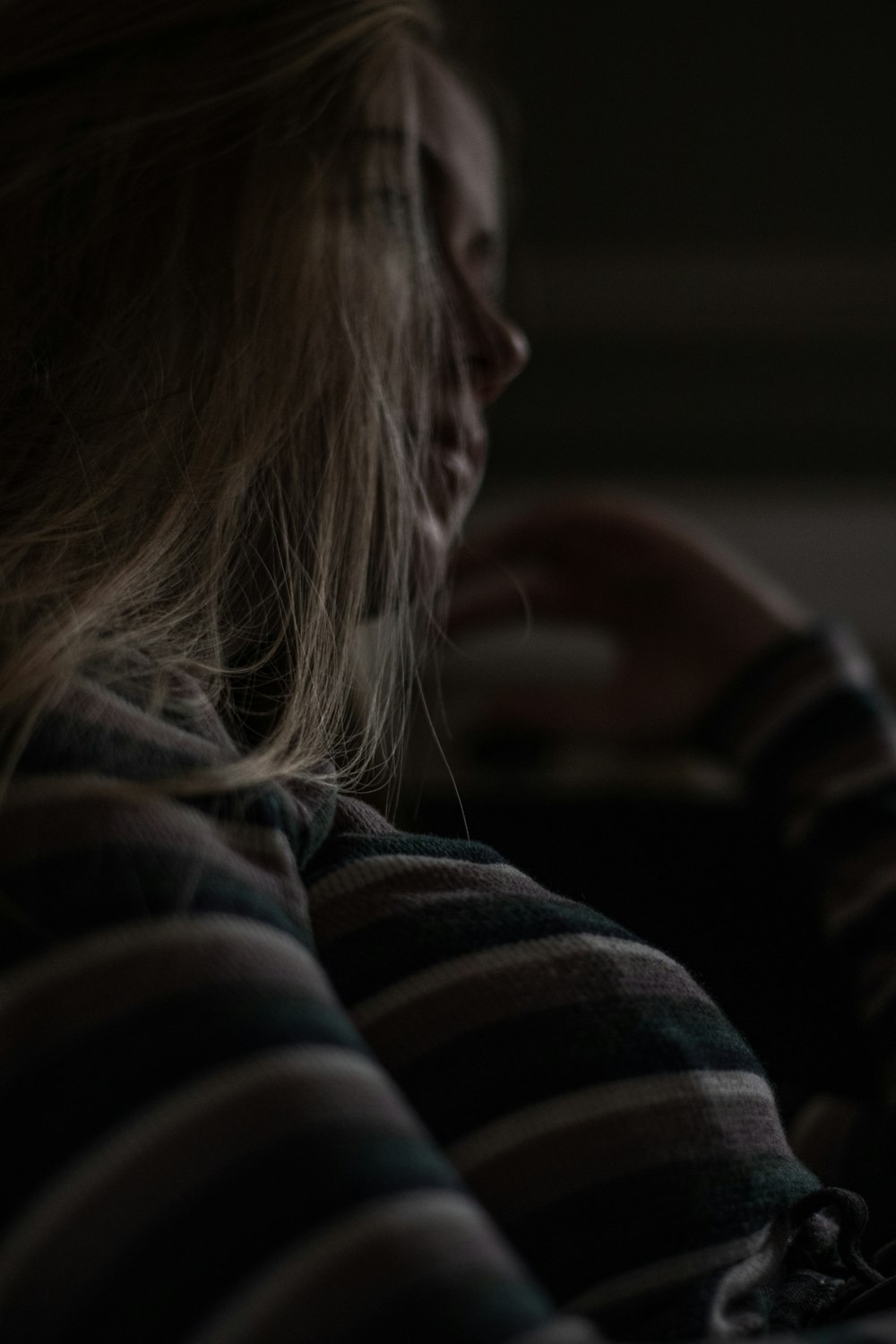 woman in gray and white striped long sleeve shirt