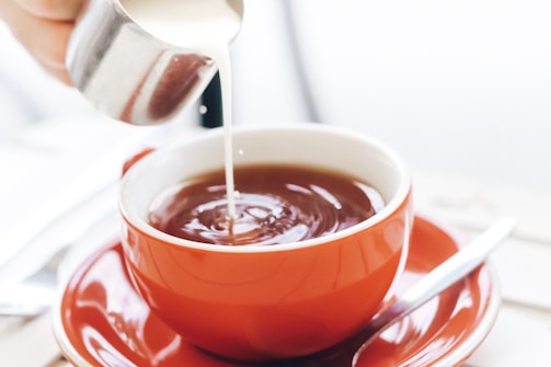 red liquid in white ceramic cup