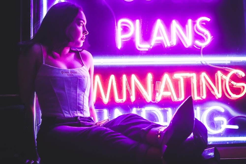 woman in white long sleeve shirt sitting on the floor