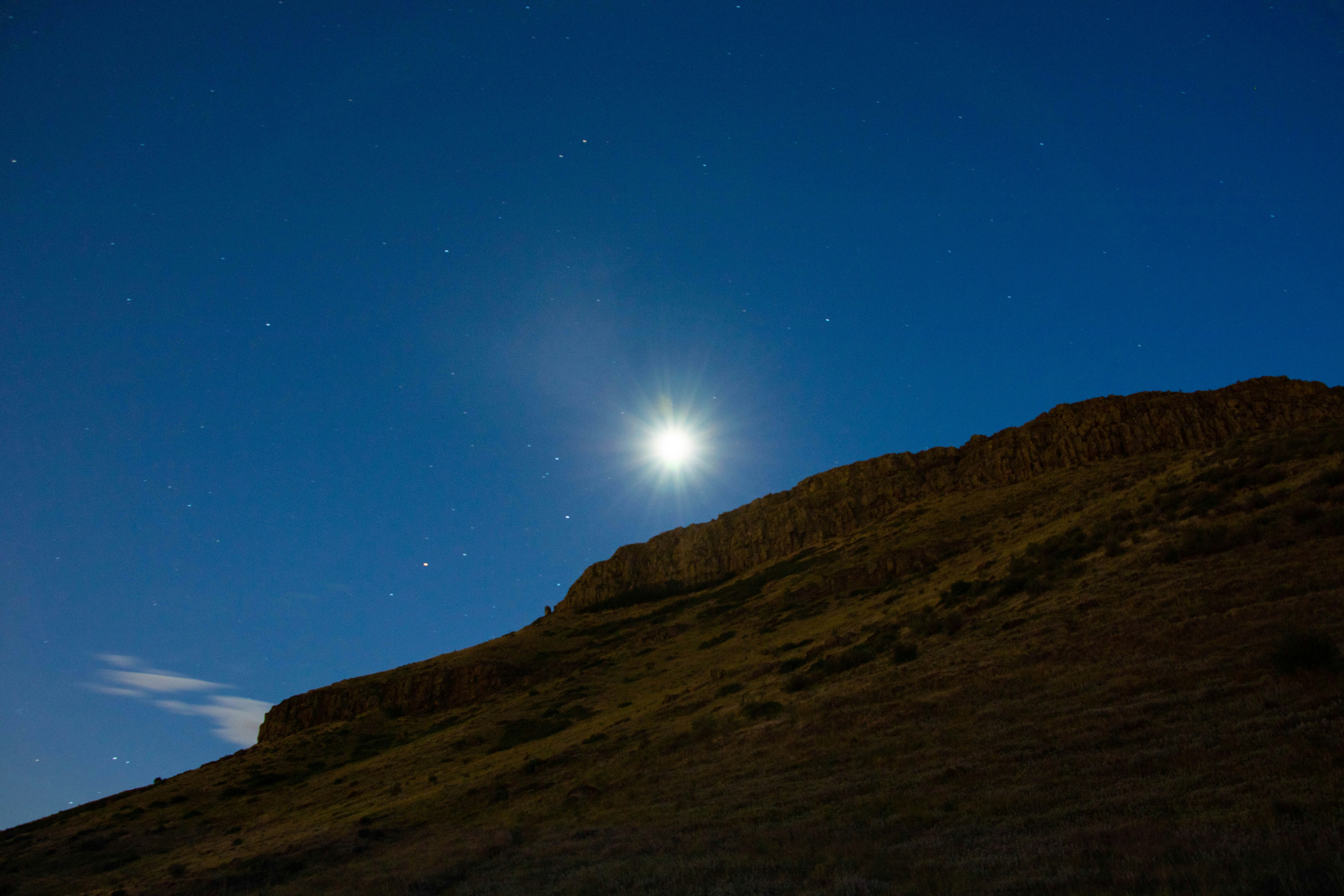 silhouette of mountain under blue sky during night time