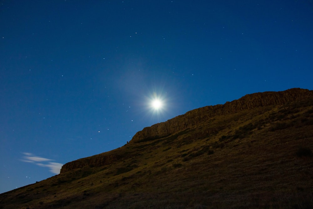 silhouette of mountain under blue sky during night time