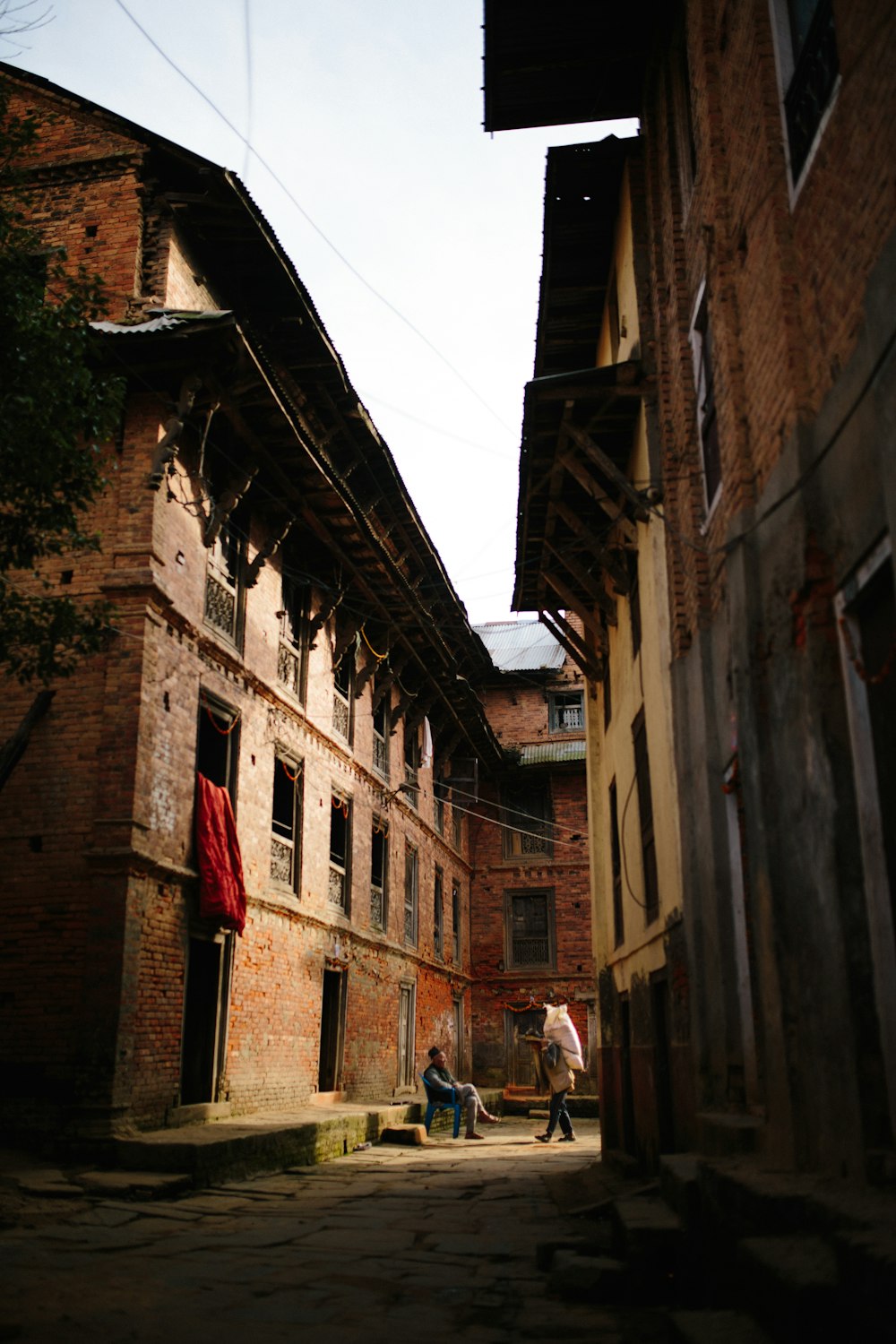 people walking on street between buildings during daytime