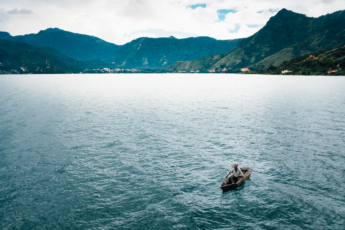 A lancha navigating the calm waters of Lake Atitlan