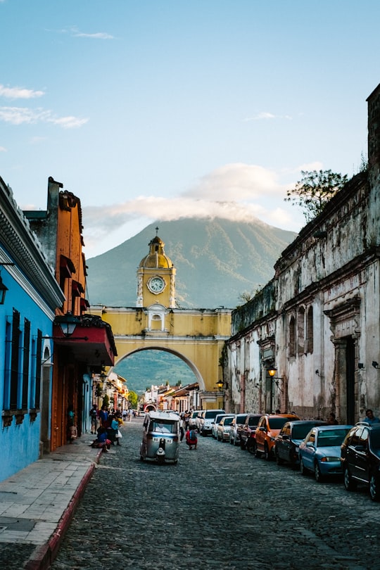 cars parked beside concrete building during daytime in Santa Catalina Arch Guatemala