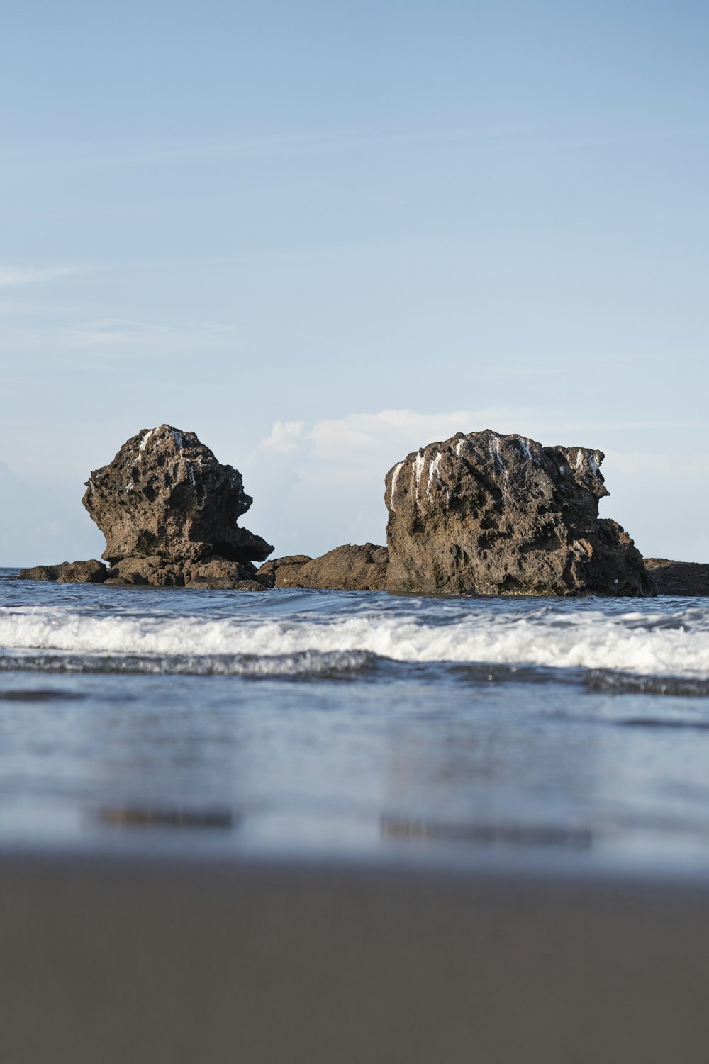 brown rock formation on sea water during daytime