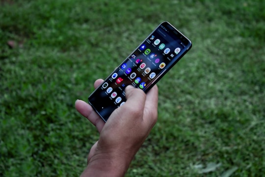 A smartphone displaying a sleek, user-friendly app interface in use outdoors.