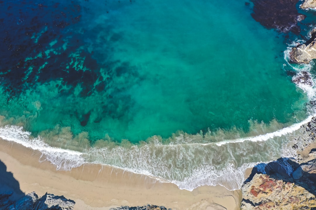 aerial view of ocean waves on shore during daytime