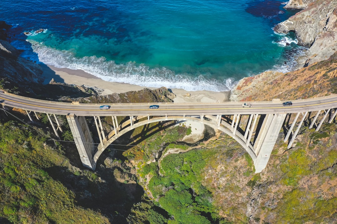 white metal bridge over blue sea during daytime