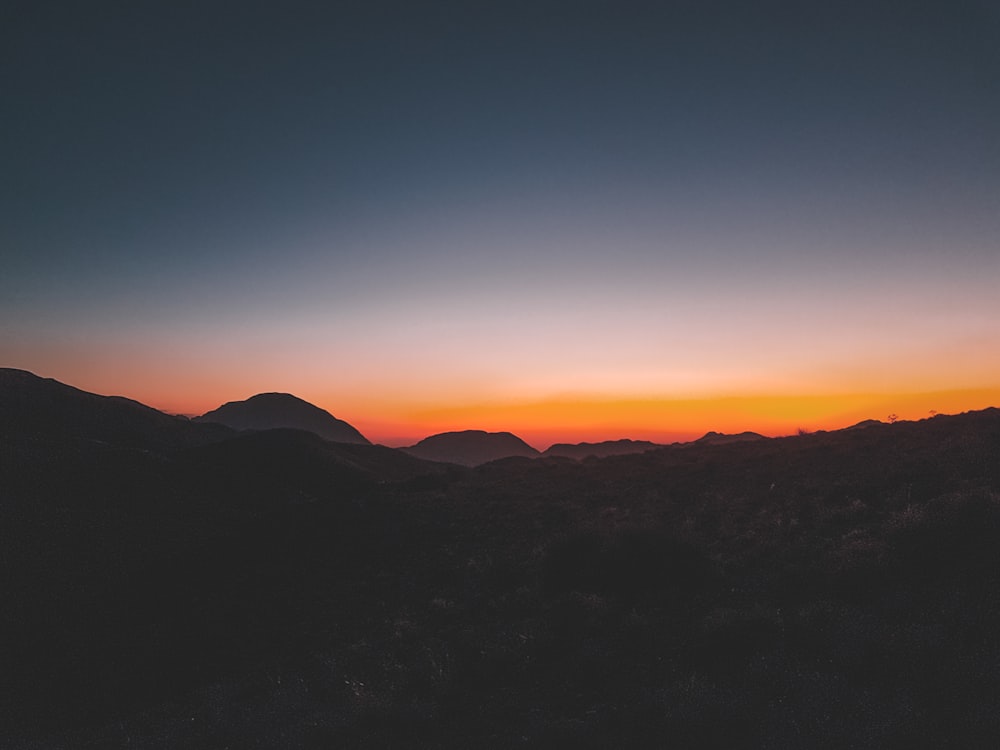 silhouette of mountain during sunset