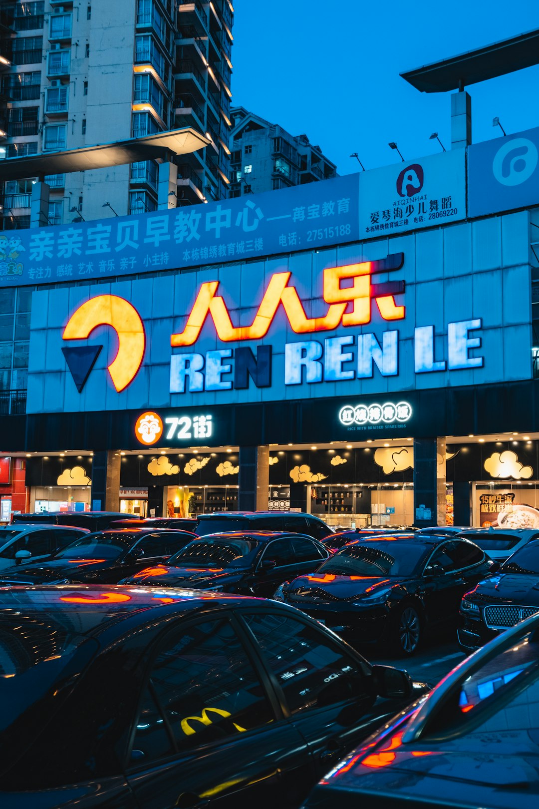 cars parked in front of blue and white building during daytime