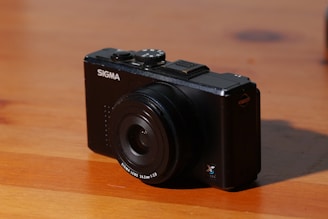 black nikon dslr camera on brown wooden table