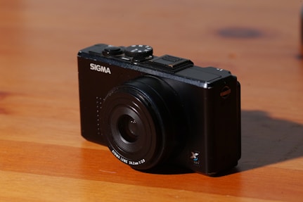 black nikon dslr camera on brown wooden table
