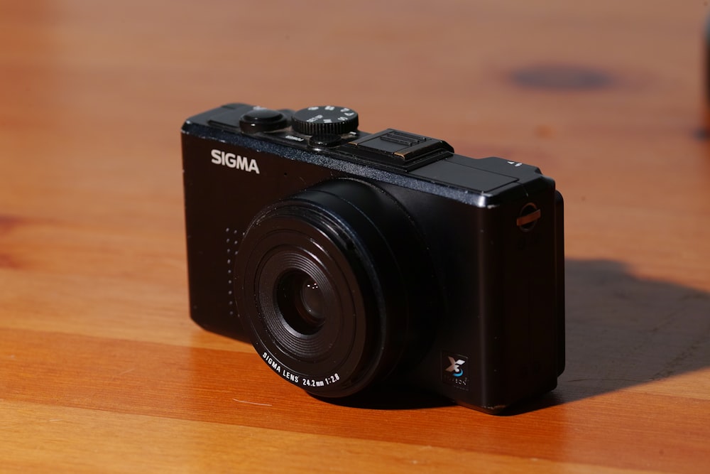 black nikon dslr camera on brown wooden table