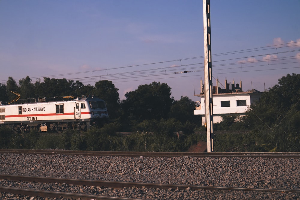 white and red train on rail tracks