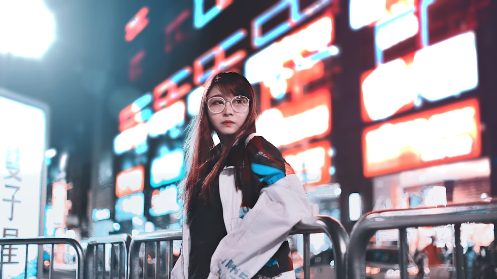 woman in white blazer and black framed eyeglasses