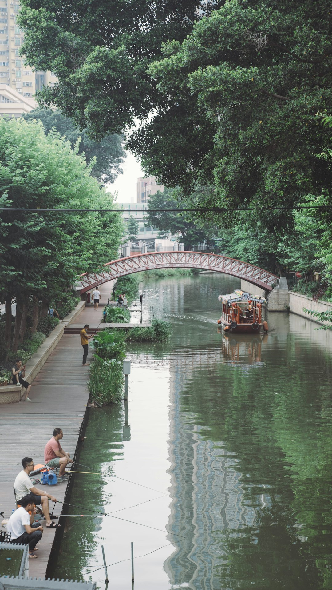 people walking on bridge over river during daytime