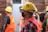 man in red blue and white plaid shirt wearing yellow hard hat