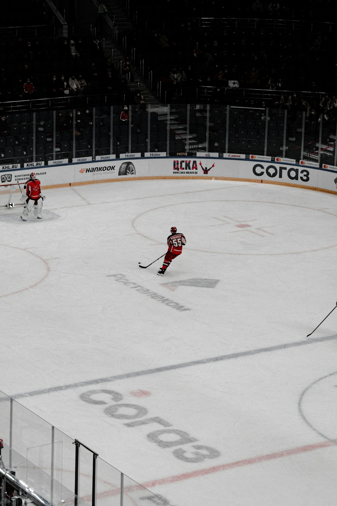 people playing ice hockey on ice stadium during daytime