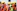 man in orange vest wearing yellow hard hat