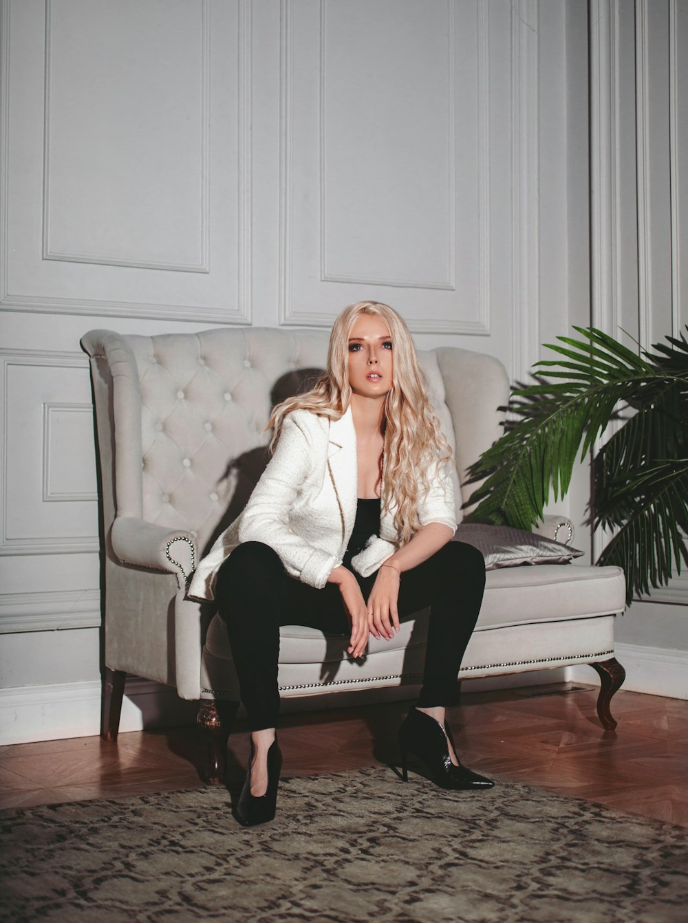 woman in white long sleeve shirt sitting on white couch