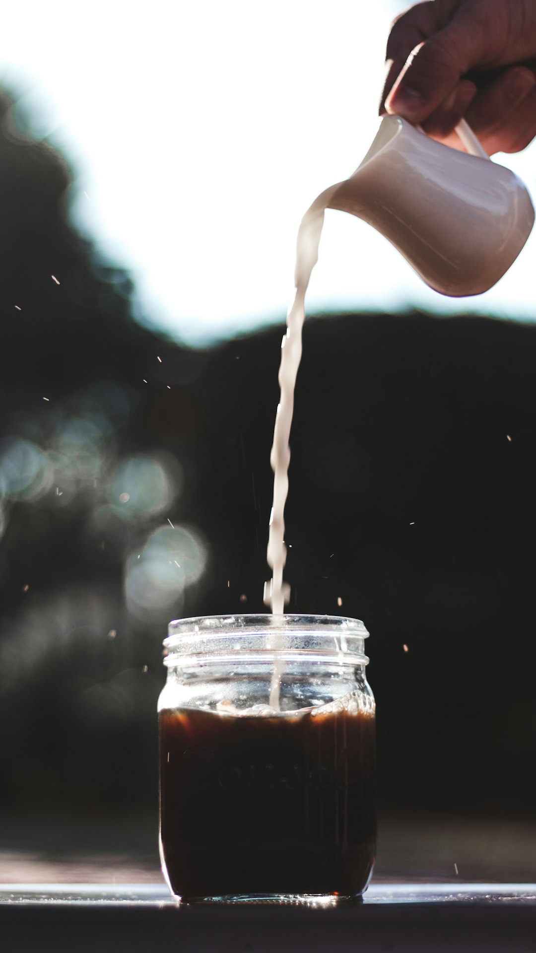 water pouring from clear glass jar